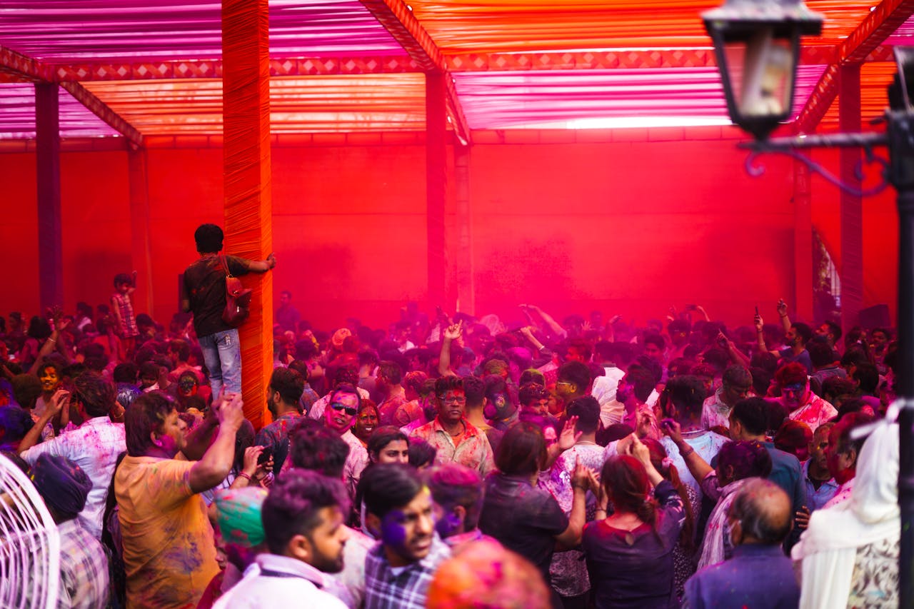 Lively celebration of Holi in Ludhiana, India with a colorful crowd enjoying the festival.