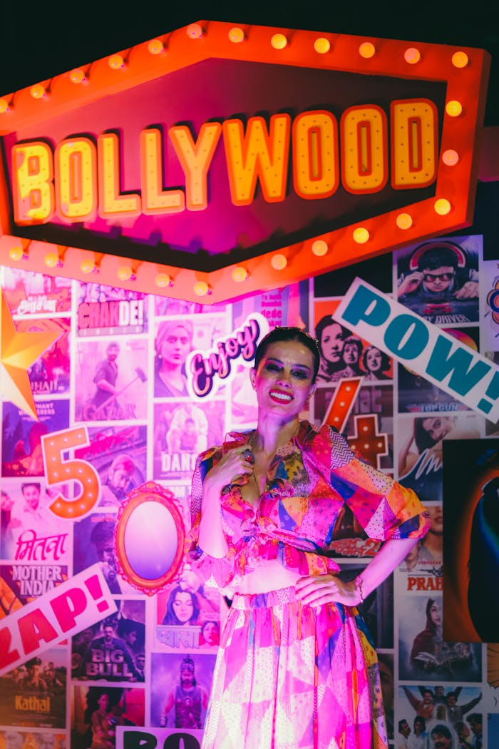 Colorful portrait of a woman in Bollywood-themed setting with vibrant lights.